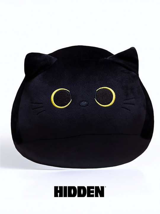 A plushie toy resembling a black cat with a cheeky expression, hidden in a playful pose.